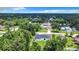 An aerial view of the home and yard showing beautiful landscaping with lush mature trees at 23113 Brewer Ave, Punta Gorda, FL 33980