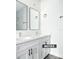 Bathroom with double sinks, black hardware, and a bright, clean aesthetic at 23113 Brewer Ave, Punta Gorda, FL 33980