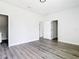 Spacious bedroom with multiple doorways and wood-look floors at 23113 Brewer Ave, Punta Gorda, FL 33980