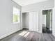 Calm bedroom with sleek floors, a window with a view, and closet with sliding doors at 23113 Brewer Ave, Punta Gorda, FL 33980