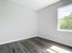 Simple bedroom features sleek floors and a window, creating a tranquil and minimalist space at 23113 Brewer Ave, Punta Gorda, FL 33980