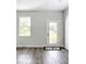 This dining room features a white door with a window and hardwood floors at 23113 Brewer Ave, Punta Gorda, FL 33980