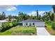Lovely one-story home with a well-maintained lawn, paved driveway, and an attached two-car garage at 23113 Brewer Ave, Punta Gorda, FL 33980