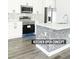Modern kitchen with stainless steel appliances, a decorative backsplash, stone kitchen island, and white cabinetry at 23113 Brewer Ave, Punta Gorda, FL 33980