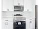 Modern kitchen with stainless steel appliances, white cabinets, and quartz countertops, ready for cooking at 23113 Brewer Ave, Punta Gorda, FL 33980