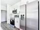 Modern kitchen with stainless steel appliances, white cabinets, and quartz countertops at 23113 Brewer Ave, Punta Gorda, FL 33980