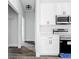 Bright kitchen with modern stainless steel appliances, white cabinets, and wood-look flooring at 23113 Brewer Ave, Punta Gorda, FL 33980