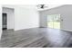Spacious living room with sleek floors, sliding glass doors, and ample natural light at 23113 Brewer Ave, Punta Gorda, FL 33980