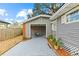 Backyard featuring a detached garage with patio area, gravel landscaping, and privacy fencing at 2912 W Frierson W Ave, Tampa, FL 33614