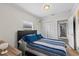 This bedroom has a closet with bi-fold doors and is decorated with calming, neutral colors for relaxation at 2912 W Frierson W Ave, Tampa, FL 33614