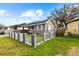 Charming home featuring a white fence, well-manicured lawn, solar panels and inviting front porch at 2912 W Frierson W Ave, Tampa, FL 33614