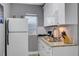 The efficiently designed kitchen features stainless steel appliances, granite countertops, and white cabinets at 2912 W Frierson W Ave, Tampa, FL 33614