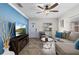 Inviting living room with neutral colors, tile flooring, and bright light from the front door and window at 2912 W Frierson W Ave, Tampa, FL 33614
