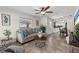 Comfortable living room featuring a neutral color palette, ceiling fan, and ample natural light at 2912 W Frierson W Ave, Tampa, FL 33614