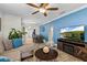 Inviting living room with comfortable seating, ceiling fan, and an open view to the dining area at 2912 W Frierson W Ave, Tampa, FL 33614