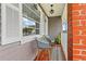 Charming front porch with brick accents, modern outdoor seating, and a welcoming aesthetic for guests at 2912 W Frierson W Ave, Tampa, FL 33614