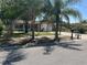Charming single-story home featuring a well-maintained front yard with mature palm trees and a lovely porch at 1912 W Clinton St, Tampa, FL 33604