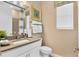 Neat bathroom featuring a granite-style countertop, ample lighting, and fresh white towels at 9143 Players Dr, Weeki Wachee, FL 34613