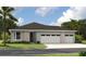 Charming single-story home with a two-car garage and beautifully manicured lawn at 9143 Players Dr, Weeki Wachee, FL 34613