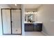 Modern bathroom featuring a double vanity, sleek fixtures, and a glass-enclosed shower with tiled walls at 9176 Players Dr, Weeki Wachee, FL 34613