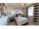 Comfortable bedroom with neutral tones, a window providing natural light, and baseball-themed decor at 9176 Players Dr, Weeki Wachee, FL 34613