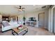 Spacious living room featuring stylish decor, a ceiling fan, lots of light, and open access to the kitchen at 9176 Players Dr, Weeki Wachee, FL 34613