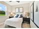 Bright bedroom with a ceiling fan, black bedside tables and blue decorative pillows at 9177 Players Dr, Weeki Wachee, FL 34613