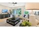 Spacious living room with contemporary furniture, a large coffee table, and views of the outdoors at 9177 Players Dr, Weeki Wachee, FL 34613