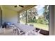 Inviting screened patio with comfortable seating and a view of lush greenery at 9177 Players Dr, Weeki Wachee, FL 34613