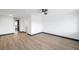 Bright, open room with hardwood floors, a ceiling fan, neutral walls, and dark trim at 2353 Shelley St # 10, Clearwater, FL 33765