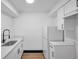 Modern kitchen showcases white cabinetry, stainless steel sink with a black faucet, and a white refrigerator at 2353 Shelley St # 10, Clearwater, FL 33765
