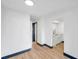 Open concept living area featuring wood-look floors with a connecting kitchen space at 2353 Shelley St # 10, Clearwater, FL 33765