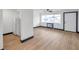 Inviting living area with wood-look floors, a large window with natural light, and an adjacent kitchen at 2353 Shelley St # 10, Clearwater, FL 33765