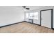 Bright living room with wood-look flooring, a large window, and a sleek ceiling fan at 2353 Shelley St # 10, Clearwater, FL 33765