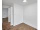 Neutral bedroom featuring hard surface floors, freshly painted white walls and updated door at 2353 Shelley St # 18, Clearwater, FL 33765
