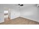 Bright bedroom featuring wood floors, a ceiling fan, and doorway view at 2353 Shelley St # 18, Clearwater, FL 33765