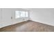 Living area showcasing hard surface floors, freshly painted white walls, door and window at 2353 Shelley St # 18, Clearwater, FL 33765