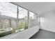 Bright sunroom featuring large windows offering an outside view, and dark flooring at 2353 Shelley St # 18, Clearwater, FL 33765