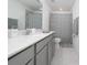 Clean bathroom featuring a vanity with a large mirror and a shower-tub combination at 3884 Capri Coast Dr, Plant City, FL 33565