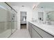 Bright bathroom featuring double sinks, sleek vanity, large mirror, and walk-in shower at 3884 Capri Coast Dr, Plant City, FL 33565
