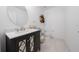 Well-lit half bath features a decorative mirror and a dark vanity with white countertop at 3884 Capri Coast Dr, Plant City, FL 33565