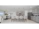 Open-concept kitchen featuring stainless steel appliances, gray cabinets, a large center island, and a dining area at 3884 Capri Coast Dr, Plant City, FL 33565