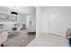 Bright living room with tile and carpet flooring, white walls, modern furniture, and a stylish contemporary light fixture at 3884 Capri Coast Dr, Plant City, FL 33565
