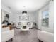 Bright living room with white walls, modern light fixture, neutral carpet, stylish furniture, and natural light from a window at 3884 Capri Coast Dr, Plant City, FL 33565