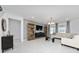 Contemporary living room featuring tile floors, a large TV, modern furniture, and natural light from the large windows at 3884 Capri Coast Dr, Plant City, FL 33565