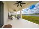 Relaxing covered patio with ceiling fans, seating, and a scenic view of the lake at 3884 Capri Coast Dr, Plant City, FL 33565