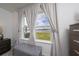 Bedroom window with views of a backyard lake, soft curtains, and bench seating at 3884 Capri Coast Dr, Plant City, FL 33565
