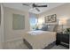 Cozy bedroom with a ceiling fan and a large window offering plenty of natural light at 6008 Jensen View Ave, Apollo Beach, FL 33572