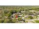 An aerial view shows the home's position near a lake, golf course, and other homes at 1025 Royal Troon Ct, Tarpon Springs, FL 34688
