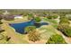 Beautiful aerial view of a golf course with mature trees surrounding a tranquil pond at 1025 Royal Troon Ct, Tarpon Springs, FL 34688